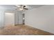 Spacious bedroom with tan carpet, ceiling fan, and a large walk-in closet at 3462 Mount Zion Rd, Stockbridge, GA 30281