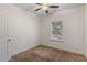 Cozy bedroom featuring neutral carpeting, a ceiling fan, and a window for natural light at 3462 Mount Zion Rd, Stockbridge, GA 30281