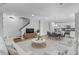 Bright, open-concept living room with white furniture, modern decor, and an adjacent dining area and kitchen at 3462 Mount Zion Rd, Stockbridge, GA 30281