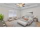 Staged main bedroom featuring neutral carpeting, a ceiling fan, and a window for natural light at 3462 Mount Zion Rd, Stockbridge, GA 30281