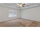 Main bedroom featuring neutral carpeting, a ceiling fan, and a window for natural light at 3462 Mount Zion Rd, Stockbridge, GA 30281
