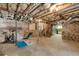 Spacious basement with exposed beams, concrete floor, exercise equipment and potential for customization at 567 E Wesley Ne Rd, Atlanta, GA 30305