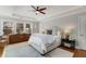 Primary bedroom with tray ceiling, ceiling fan, and lots of natural lighting at 567 E Wesley Ne Rd, Atlanta, GA 30305