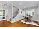 Open dining room with modern chandelier, hardwood floors, and adjacent staircase at 567 E Wesley Ne Rd, Atlanta, GA 30305