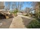 Wide driveway and backyard with stairs to elevated area and view of fence lined property at 567 E Wesley Ne Rd, Atlanta, GA 30305