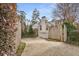 Driveway flanked by wooden fence leads to two car garage and backyard at 567 E Wesley Ne Rd, Atlanta, GA 30305