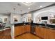 Bright eat-in kitchen with wood cabinets, black countertops, stainless steel appliances, and hardwood flooring at 567 E Wesley Ne Rd, Atlanta, GA 30305