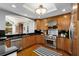 Modern kitchen features stainless steel appliances, wood cabinets, black countertops, and hardwood floors at 567 E Wesley Ne Rd, Atlanta, GA 30305