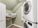Efficient laundry room with stacked washer and dryer, storage cabinets, and functional design at 567 E Wesley Ne Rd, Atlanta, GA 30305