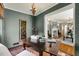 Bright and airy study/office space with gray brick walls, a chandelier, and a view of the living room at 567 E Wesley Ne Rd, Atlanta, GA 30305