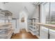 Spacious walk-in closet featuring custom shelving, storage racks, and natural light from the window at 567 E Wesley Ne Rd, Atlanta, GA 30305