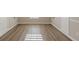 Wood-look flooring in sun-drenched bedroom with white trim and neutral walls at 104 Sunflower Meadows Dr, Mcdonough, GA 30252