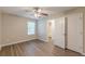Comfortable bedroom with wood-look floors, window, and closet with an adjoining bathroom at 104 Sunflower Meadows Dr, Mcdonough, GA 30252