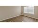 A light-filled bedroom boasts a large window and wood-look flooring at 104 Sunflower Meadows Dr, Mcdonough, GA 30252