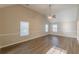 Large bedroom featuring vaulted ceiling, windows, and wood-look floors at 104 Sunflower Meadows Dr, Mcdonough, GA 30252