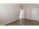 Well-lit bedroom with neutral walls and wood-look floors and two entryways at 104 Sunflower Meadows Dr, Mcdonough, GA 30252