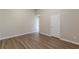 A naturally lit bedroom featuring wood-look floors and neutral walls at 104 Sunflower Meadows Dr, Mcdonough, GA 30252