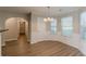 Dining room features wood floors, wainscoting, chandelier, and windows at 104 Sunflower Meadows Dr, Mcdonough, GA 30252
