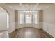 Traditional dining room featuring a bay window, an elegant chandelier, and hardwood floors at 104 Sunflower Meadows Dr, Mcdonough, GA 30252
