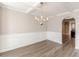 Traditional dining room with stylish chandelier, wainscoting, and coffered ceilings at 104 Sunflower Meadows Dr, Mcdonough, GA 30252