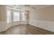 Bright dining room with stylish chandelier, wainscoting, bay windows, and coffered ceilings at 104 Sunflower Meadows Dr, Mcdonough, GA 30252