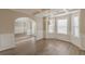 Well-lit dining room featuring a bay window, an elegant chandelier, and hardwood floors at 104 Sunflower Meadows Dr, Mcdonough, GA 30252