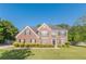 Charming two-story brick home with manicured lawn and mature landscaping at 104 Sunflower Meadows Dr, Mcdonough, GA 30252