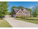 Brick home with attached two-car garage and long drive on a sunny day at 104 Sunflower Meadows Dr, Mcdonough, GA 30252
