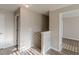 Hallway with wood-look floors and access to several rooms from the stair landing at 104 Sunflower Meadows Dr, Mcdonough, GA 30252
