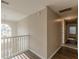 Hallway with wood-look floors, white banister, pendant lighting, and natural light at 104 Sunflower Meadows Dr, Mcdonough, GA 30252