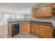 Well-maintained kitchen with dark countertops, oak cabinetry, and modern appliances at 104 Sunflower Meadows Dr, Mcdonough, GA 30252