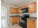 Kitchen features wood cabinets, and black appliances at 104 Sunflower Meadows Dr, Mcdonough, GA 30252
