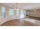 Living room features windows, fireplace, chandelier, and wood floors at 104 Sunflower Meadows Dr, Mcdonough, GA 30252