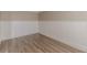 View of the corner of a room featuring wainscotting, fresh paint, and hard surface floors at 104 Sunflower Meadows Dr, Mcdonough, GA 30252