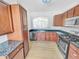 Well-equipped kitchen with stainless steel appliances and wood cabinets at 1869 Appaloosa Mill Ct, Buford, GA 30519