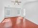 Empty bedroom with vaulted ceilings, two windows, and hardwood floors at 1869 Appaloosa Mill Ct, Buford, GA 30519