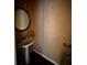 Small bathroom with a pedestal sink and vanity mirror at 305 Savannah Pl, Douglasville, GA 30134