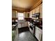 Kitchen featuring white cabinets, stainless steel appliances and black countertops at 305 Savannah Pl, Douglasville, GA 30134