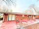 A backyard featuring a brick exterior and red concrete patio at 3276 Pin Oak Cir, Doraville, GA 30340