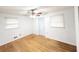 This bedroom features hardwood floors, windows, ceiling fan, and neutral paint at 3276 Pin Oak Cir, Doraville, GA 30340