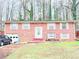 Charming brick home featuring an attached garage and manicured front lawn at 3276 Pin Oak Cir, Doraville, GA 30340