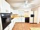 Well-lit kitchen with wood countertops, tile floor, and matching white appliances at 3276 Pin Oak Cir, Doraville, GA 30340