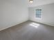 Neutral bedroom with carpeting and a bright window allowing for natural light at 3677 Utoy Sw Dr, Atlanta, GA 30331