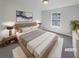 Comfortable bedroom with a plush bed, soft carpet, and a bright window for natural light at 3677 Utoy Sw Dr, Atlanta, GA 30331