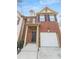 Charming two-story brick home with an attached garage, and a welcoming front door at 3677 Utoy Sw Dr, Atlanta, GA 30331