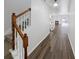 Inviting hallway with wood floors, a staircase, and a glimpse into the living room at 3677 Utoy Sw Dr, Atlanta, GA 30331