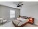 Comfortable bedroom with a ceiling fan, a large window, and modern furniture at 6162 Hutchins Dr, Buford, GA 30518