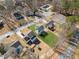 Aerial view of backyard, community tennis courts and pool, and the surrounding neighborhood at 972 Oakley Ln, Sugar Hill, GA 30518