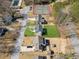 Aerial view of the home and backyard in relation to community tennis courts and pool at 972 Oakley Ln, Sugar Hill, GA 30518