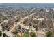 Bird's eye view of home, neighborhood, community pool, and tennis courts at 972 Oakley Ln, Sugar Hill, GA 30518